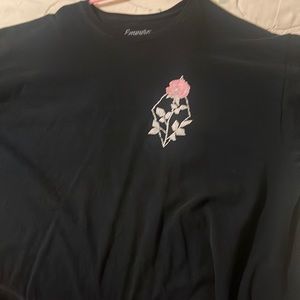 Empire brand it’s has a rose in the front of the shirt and one on the back
